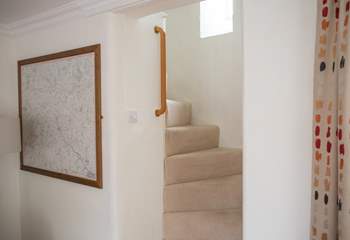 The turning cottage stairs are a delightful feature in this listed cottage, there are grab rails all the way up.