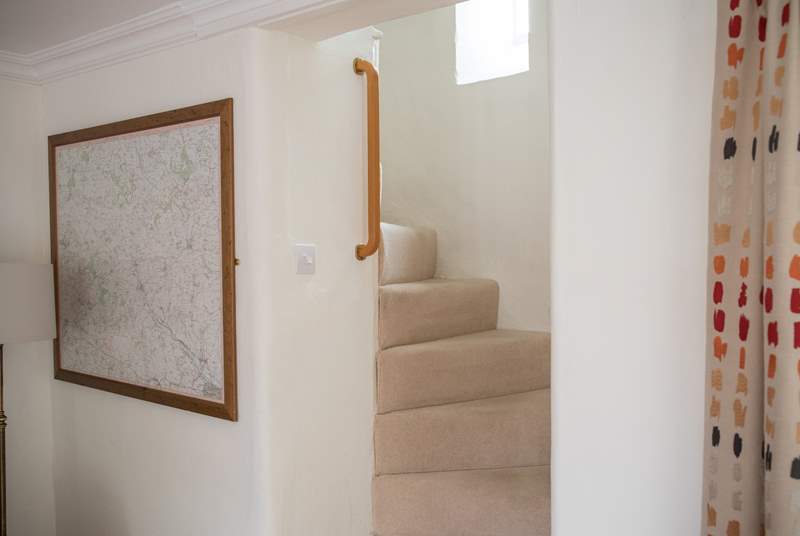 The turning cottage stairs are a delightful feature in this listed cottage, there are grab rails all the way up.