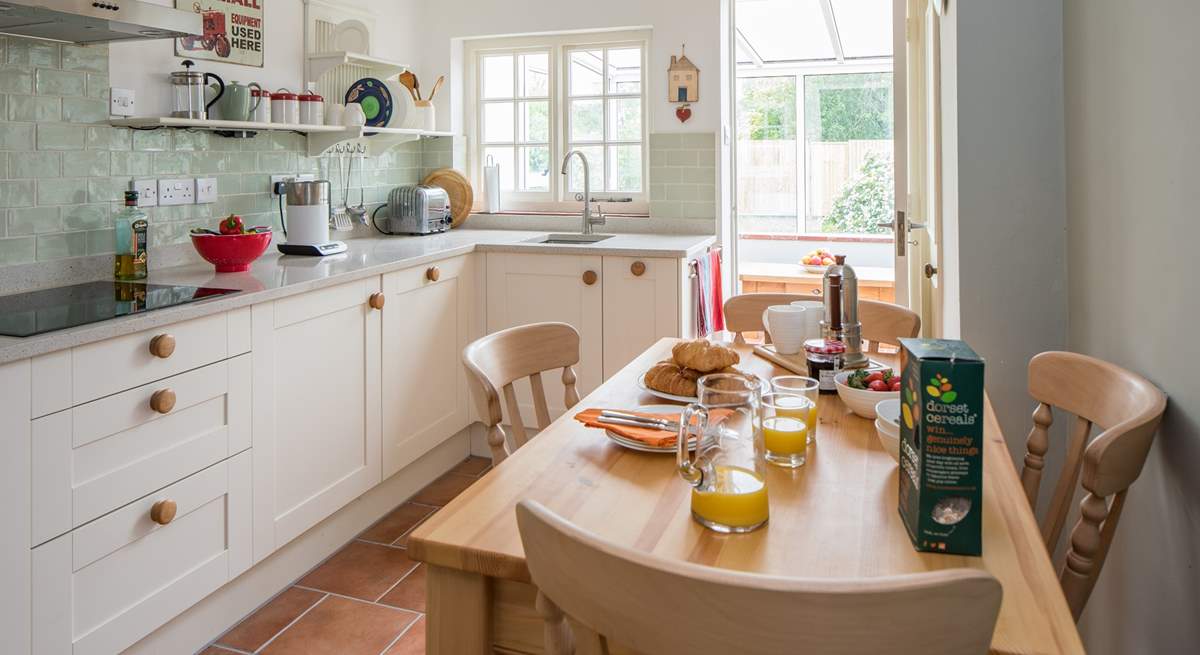 The stylish kitchen/dining-room leads out into the conservatory.