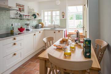 The stylish kitchen/dining-room leads out into the conservatory.