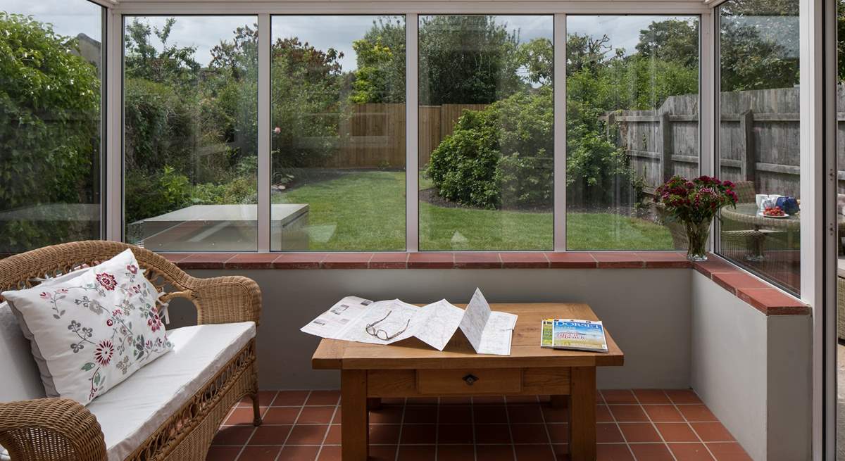 The conservatory looks out over the enclosed south-west facing garden.