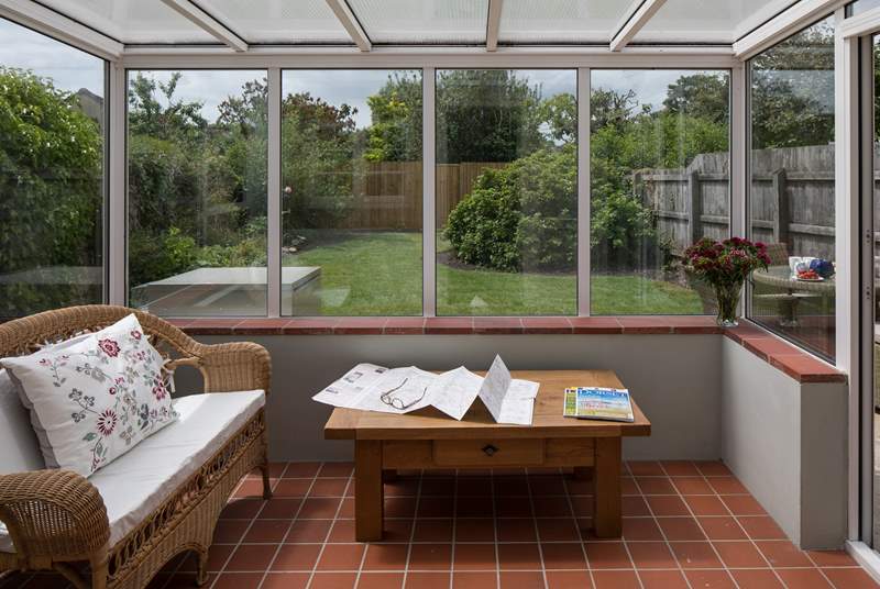 The conservatory looks out over the enclosed south-west facing garden.