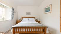 This pretty bedroom has a king-size bed and looks out over the square.