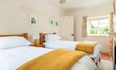 The cheerful twin room has a dual aspect over the village square at the front and to the garden at the back. - Thumbnail Image