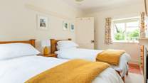 The cheerful twin room has a dual-aspect over the village square at the front and to the garden at the back.