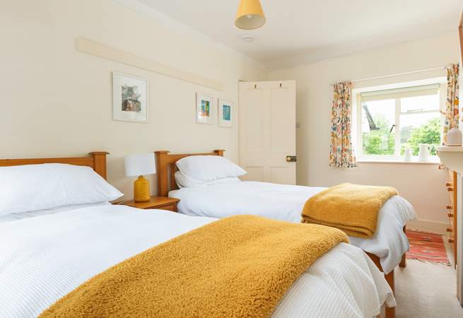 The cheerful twin room has a dual-aspect over the village square at the front and to the garden at the back.