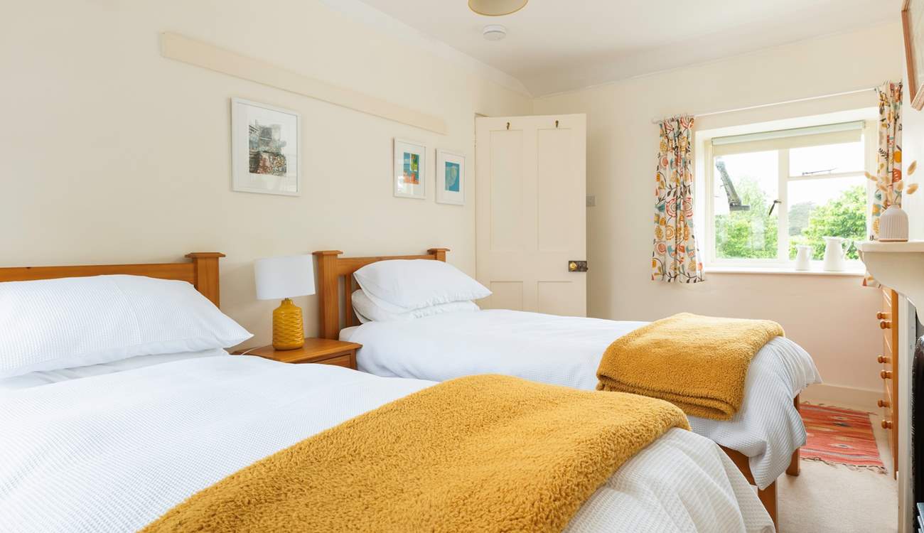 The cheerful twin room has a dual-aspect over the village square at the front and to the garden at the back.