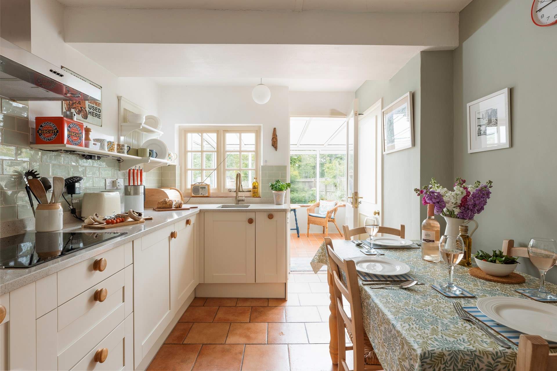 The stylish kitchen/dining-room leads out into the conservatory.