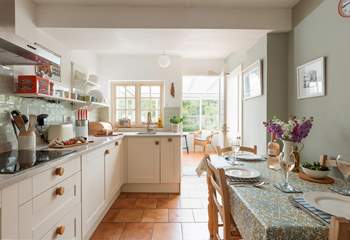 The stylish kitchen/dining-room leads out into the conservatory.