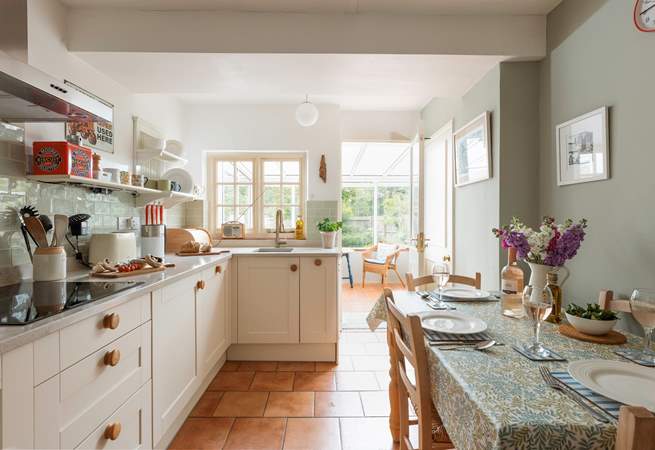 The stylish kitchen/dining-room leads out into the conservatory.