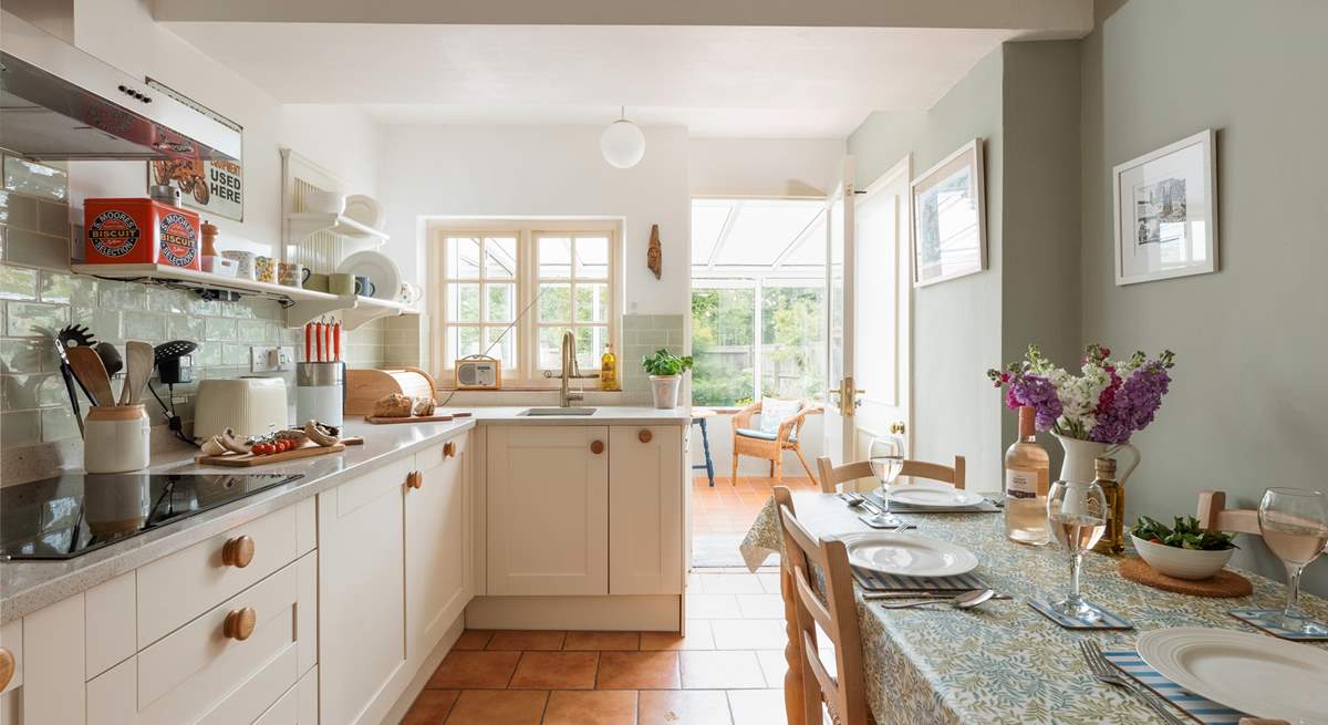 The stylish kitchen/dining-room leads out into the conservatory