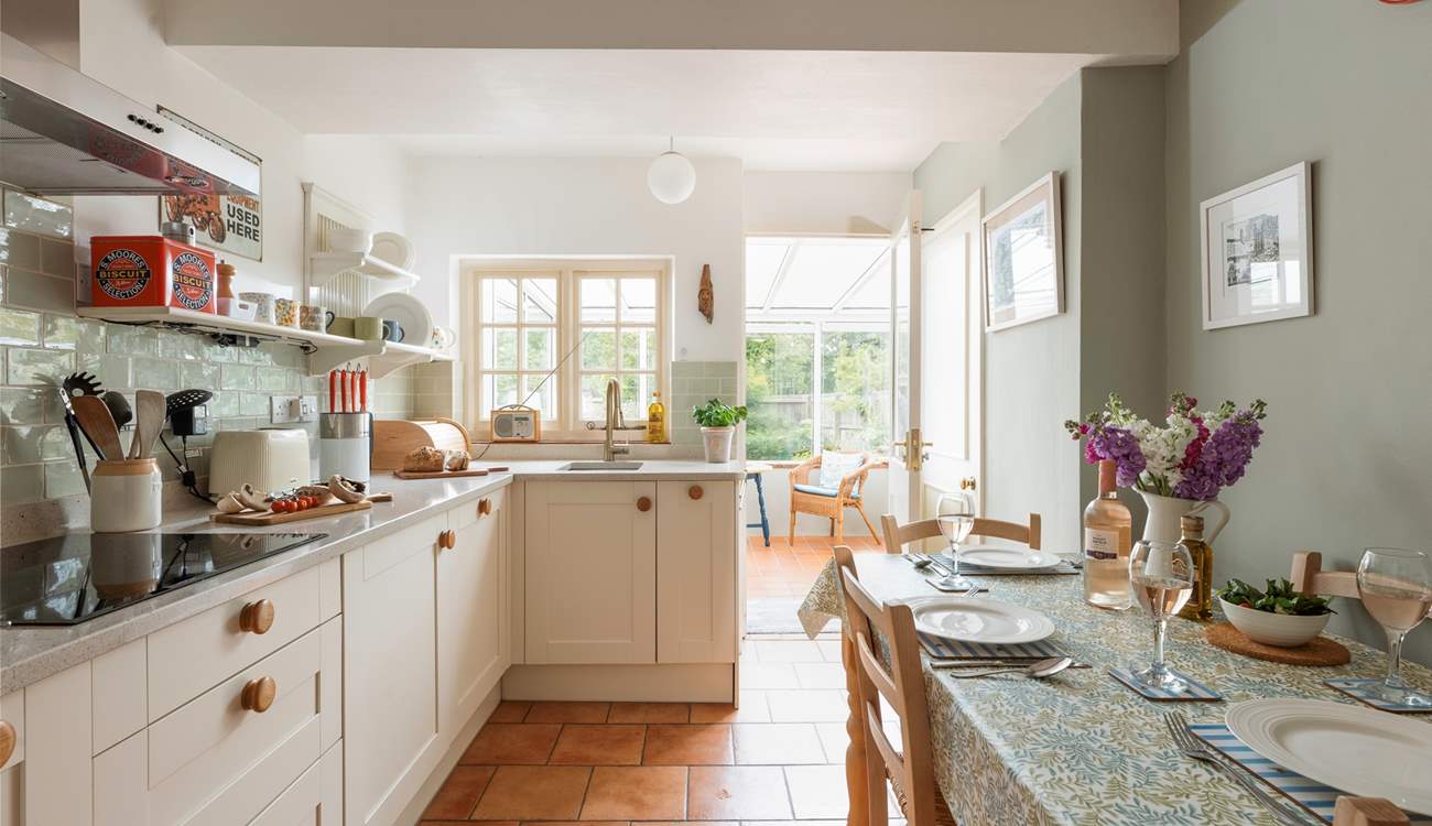 The stylish kitchen/dining-room leads out into the conservatory.