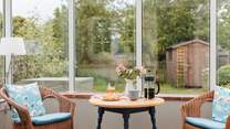 The conservatory looks out over the enclosed south-west facing garden.