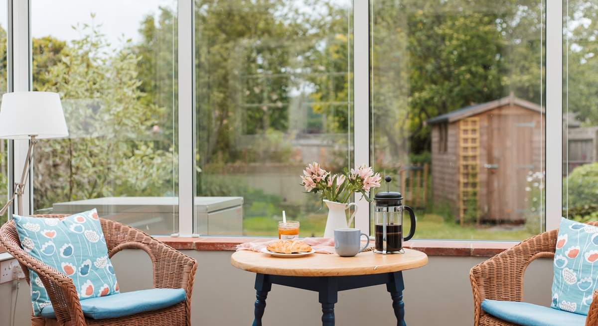 The conservatory looks out over the enclosed south-west facing garden.