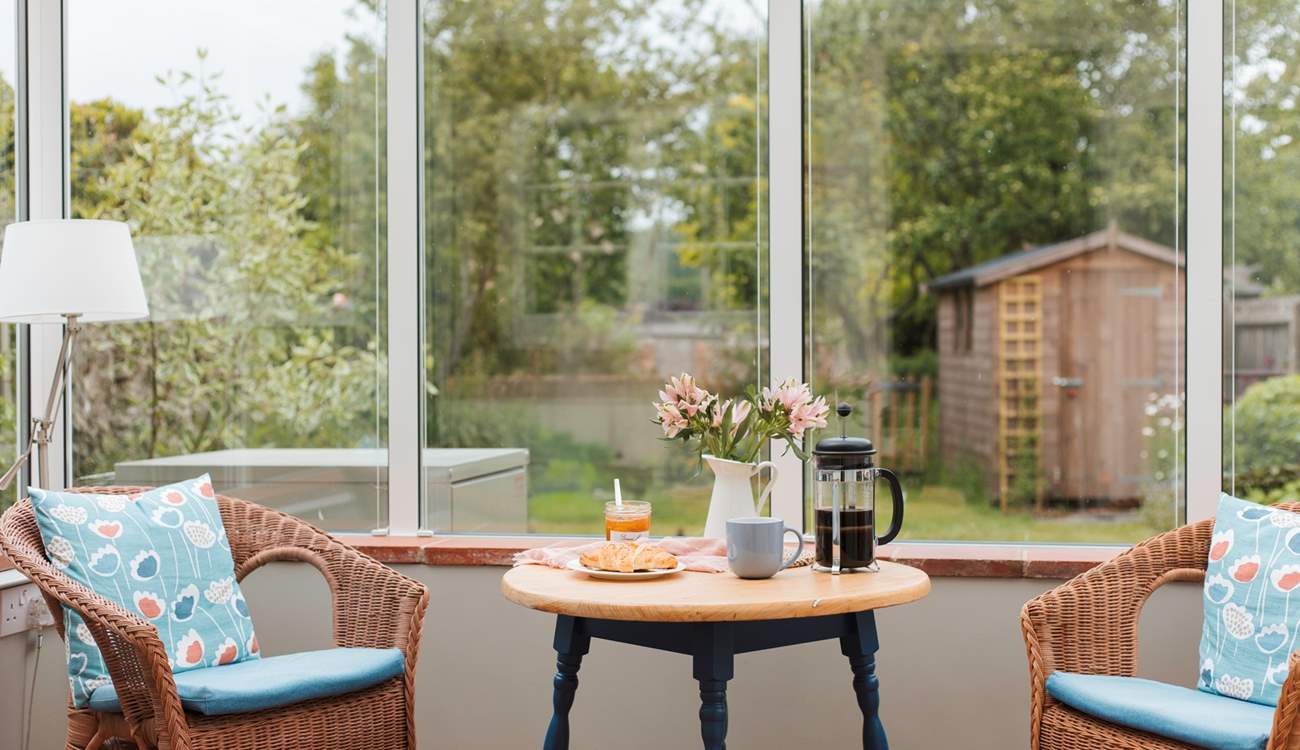 The conservatory looks out over the enclosed south-west facing garden.