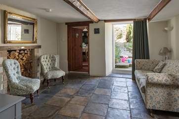 The snug with original stone flooring and French doors onto the patio-area.