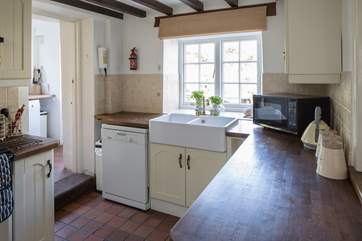 The kitchen looks out onto the patio-area, the utility-room is to the left.