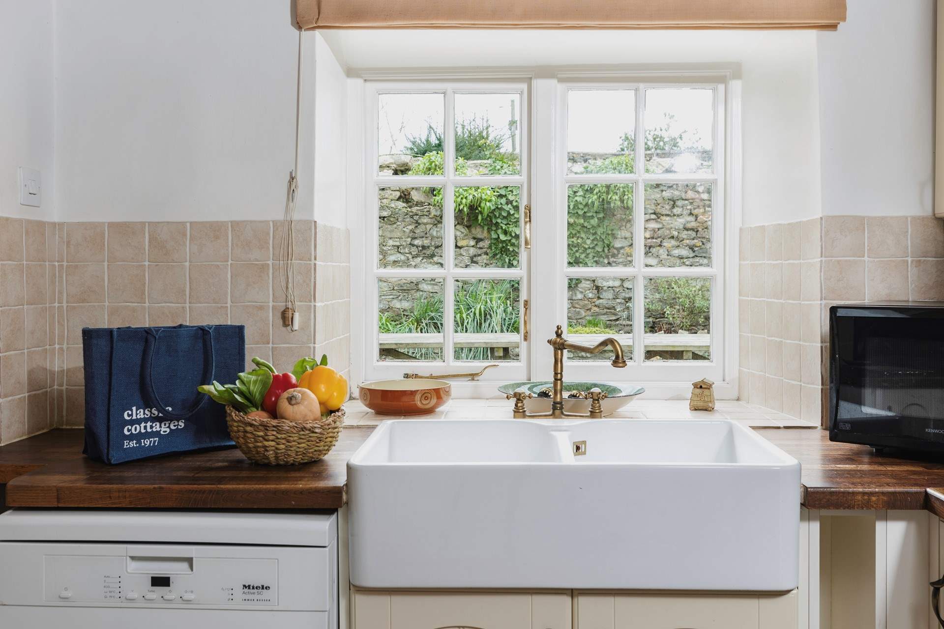 The kitchen looks out onto the patio-area, the utility-room is to the left.