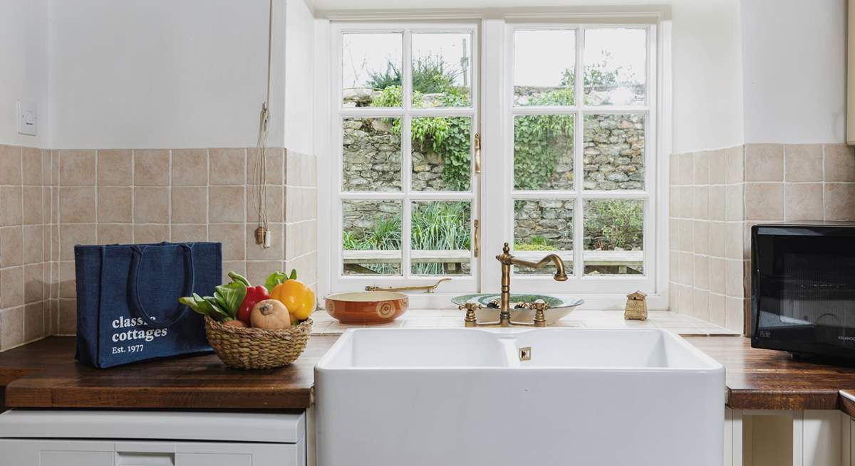 The kitchen looks out onto the patio-area, the utility-room is to the left.