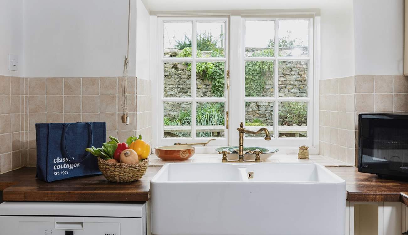 The kitchen looks out onto the patio-area, the utility-room is to the left.