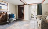 The snug with original stone flooring and French doors onto the patio-area. - Thumbnail Image