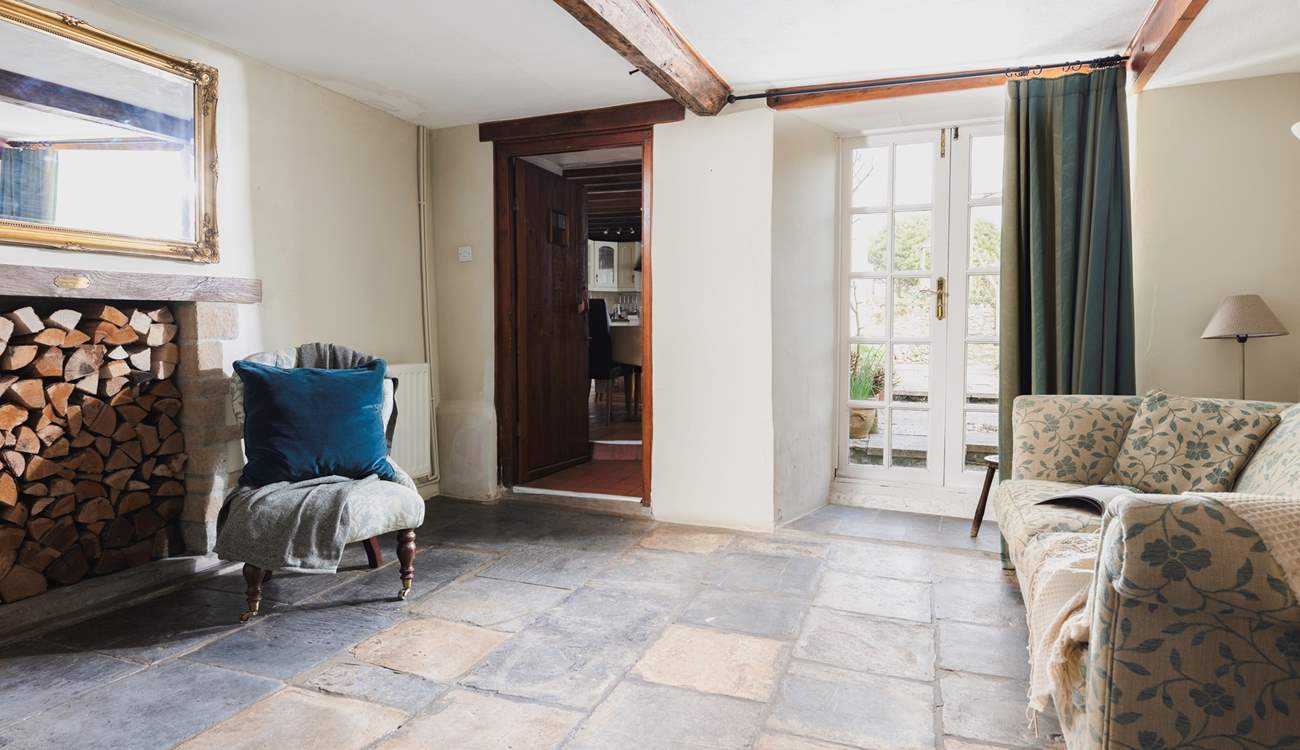 The snug with original stone flooring and French doors onto the patio-area.