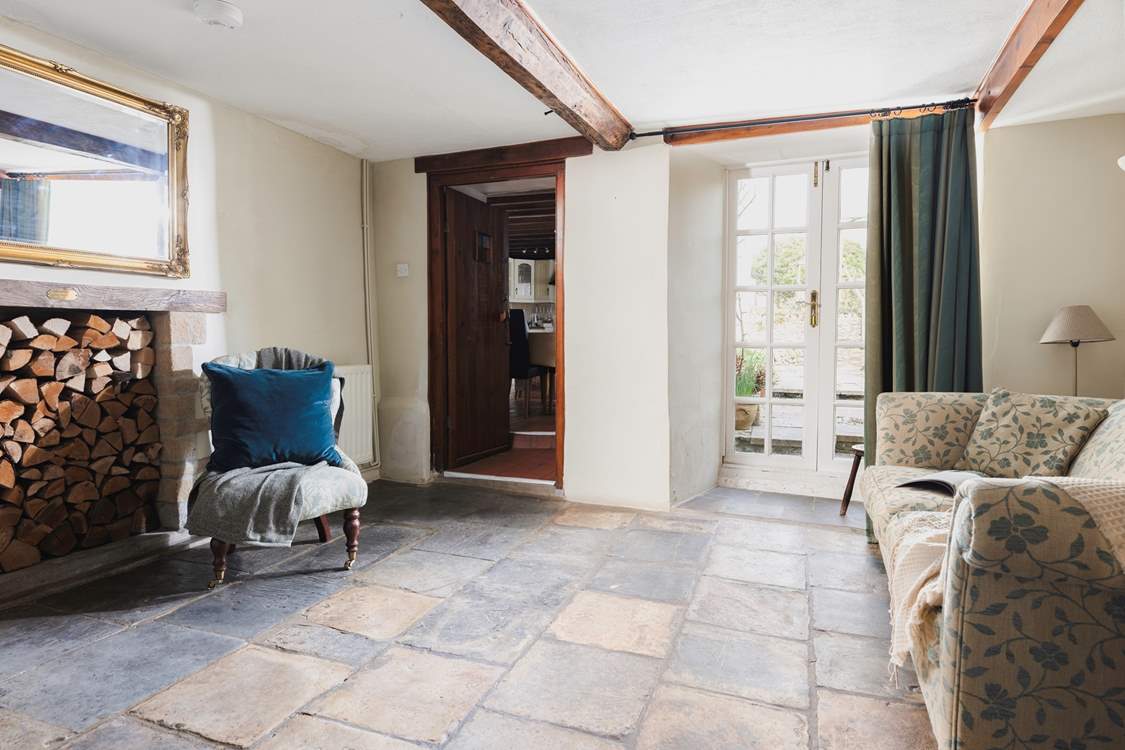 The snug with original stone flooring and French doors onto the patio-area.