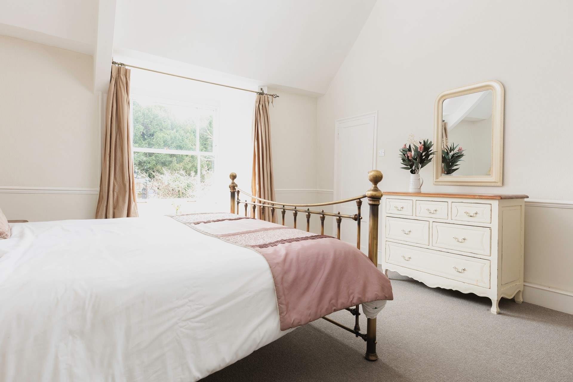 The master bedroom looks out over the church opposite. It has a super-king size bed and sea glimpses.