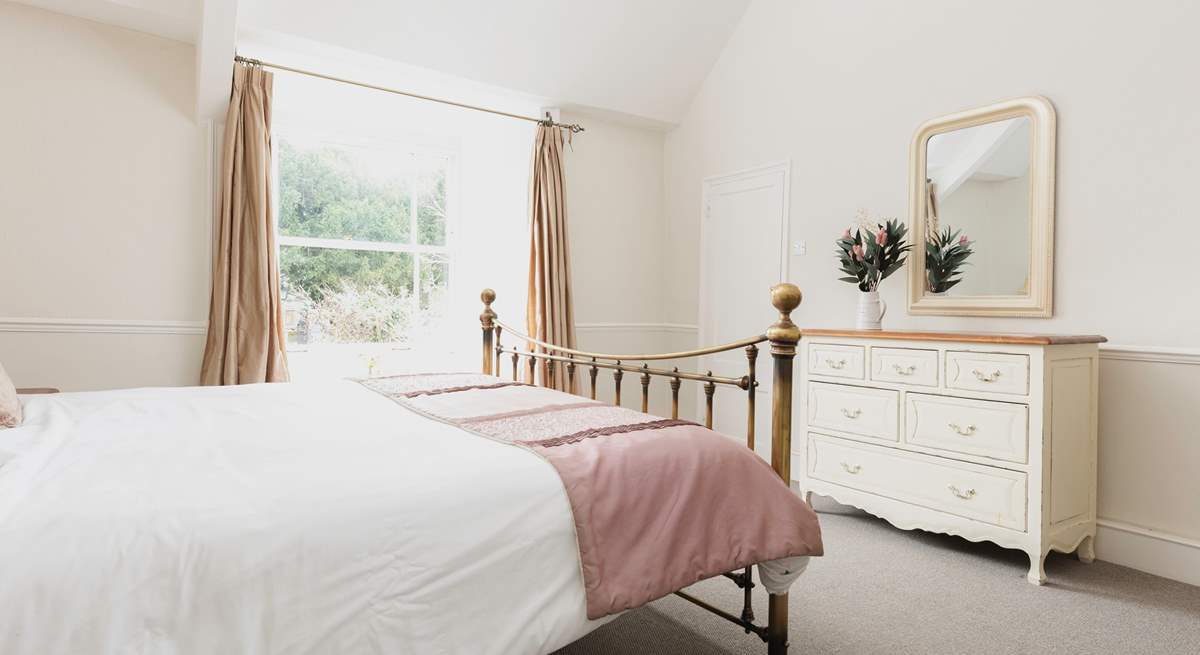 The master bedroom looks out over the church opposite. It has a super-king size bed and sea glimpses.