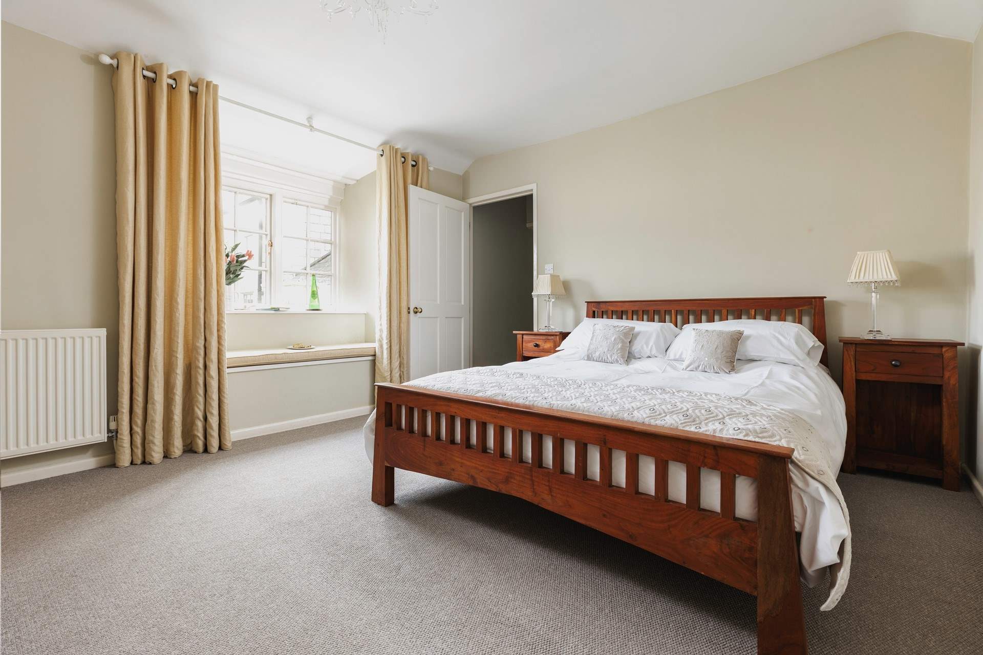 Bedroom 2 has a king-size 5' bed and views over the little patio-area at the back of the house.