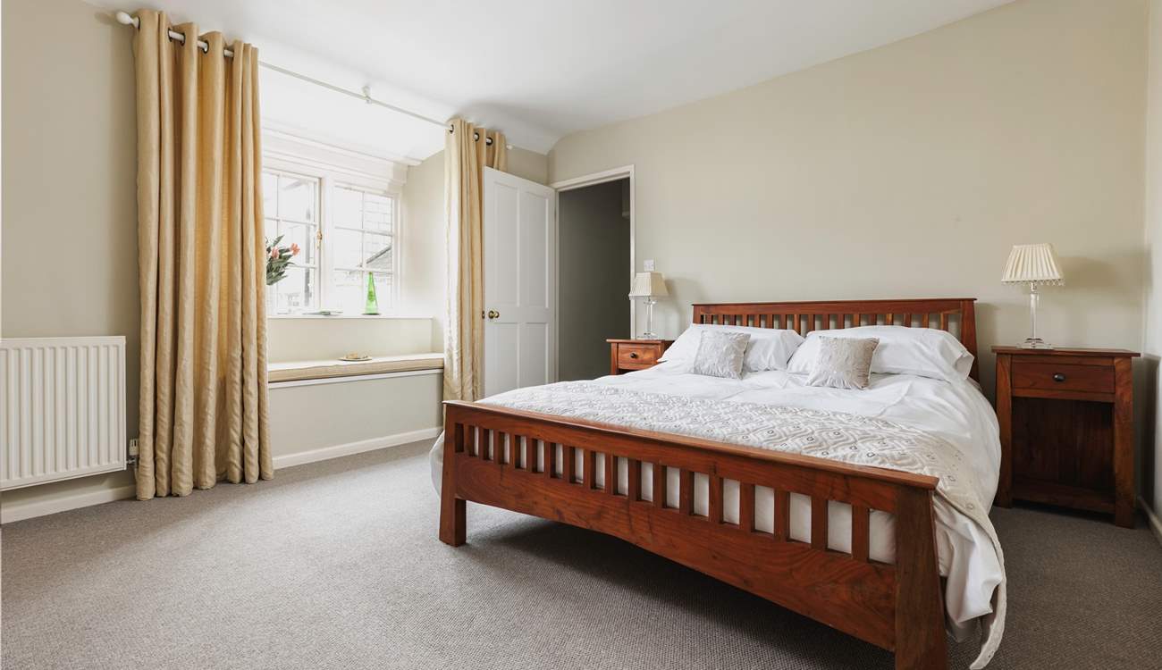 Bedroom 2 has a king-size 5' bed and views over the little patio-area at the back of the house.