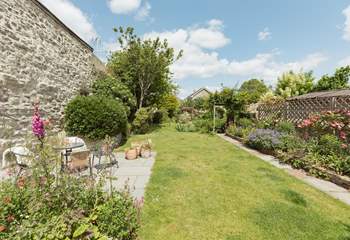 Up from the lower patio the carefully landscaped garden runs off into the distance...