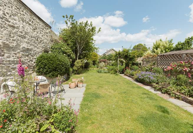 Up from the lower patio the carefully landscaped garden runs off into the distance...