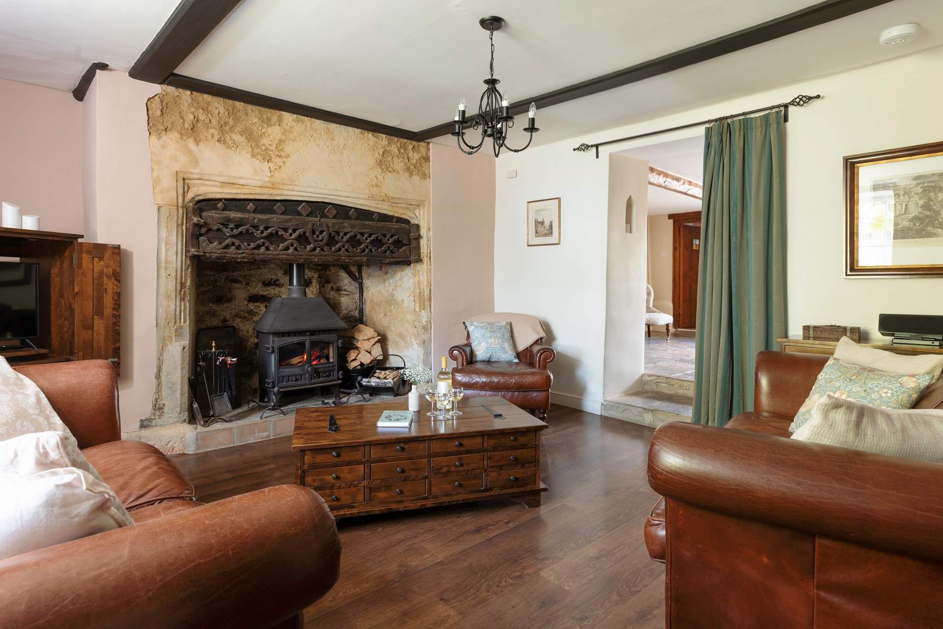 The stunning sitting-room has this magnificent fireplace and wood-burner.