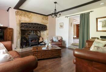 The stunning sitting-room has this magnificent fireplace and wood-burner.