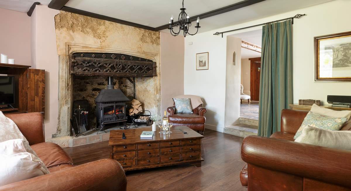 The stunning sitting-room has this magnificent fireplace and wood-burner.
