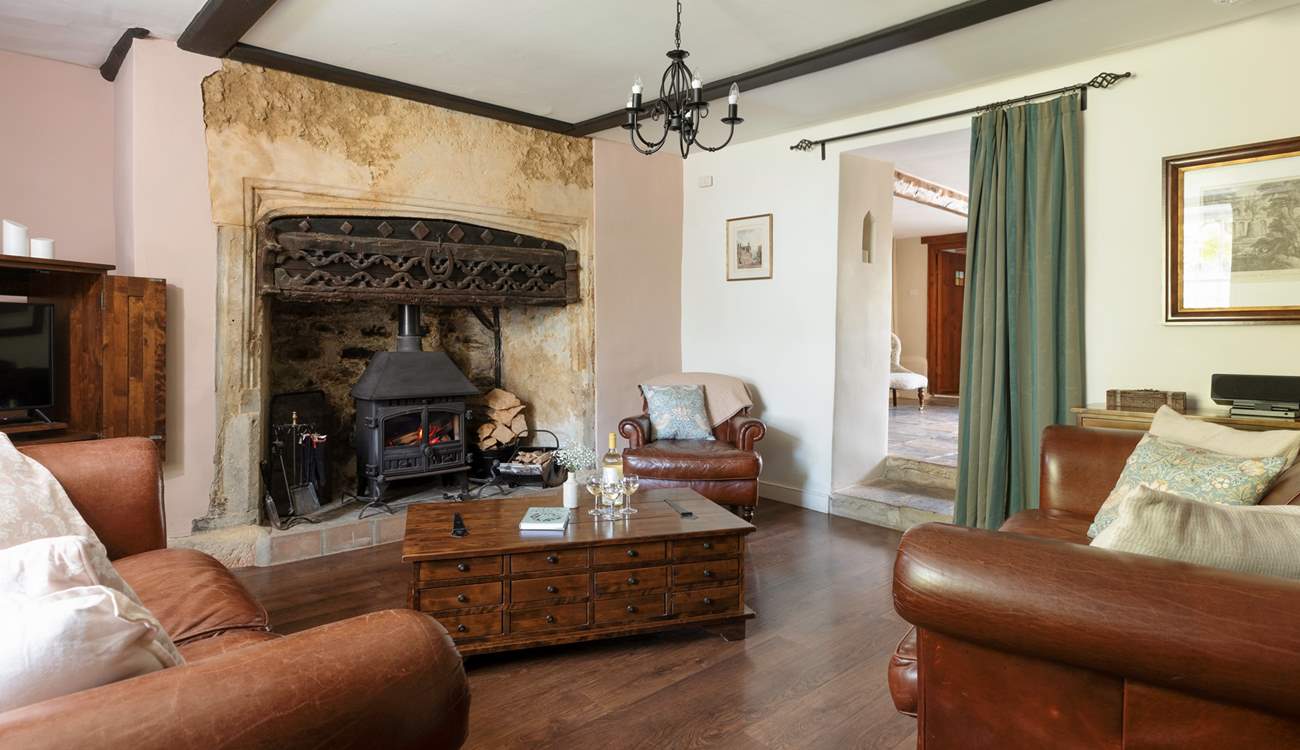 The stunning sitting-room has this magnificent fireplace and wood-burner.