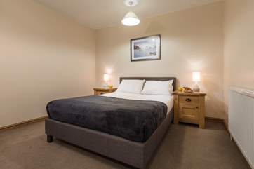 Relax in bed after a day on the beach (Bedroom 1).