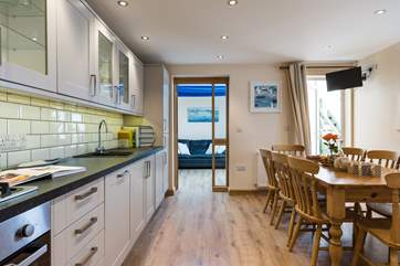 The eat-in kitchen opens to a small terrace and through to the snug.
