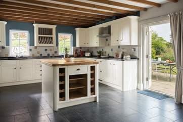 Double doors open onto the patio from the kitchen.