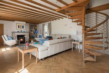 The stylish spiral staircase leads up to two bedrooms and the family bathroom.