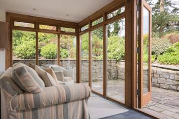 The conservatory is lovely for looking out at the garden.