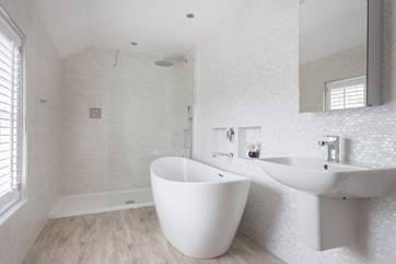 A big bath waiting to be filled with bubbles in the family bathroom.