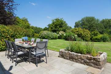 Another lovely image of the outside dining-area, perfectly positioned next to the lawn and accessed via the double doors from the kitchen.