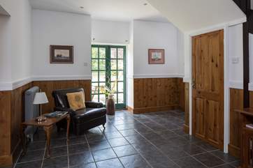 The cloakroom is to the right, beneath the stairs.
