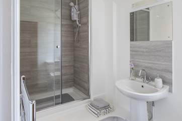 The en suite shower-room for bedroom 1, there is a step up to the shower.