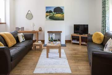 Time to relax, the spacious sitting-room has plenty of light.