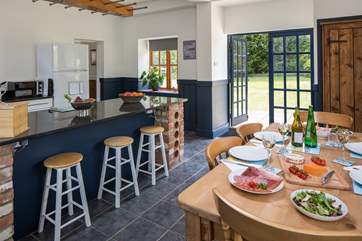 French doors lead from the kitchen/dining-room into the garden, the parking-area is outside and to the right.