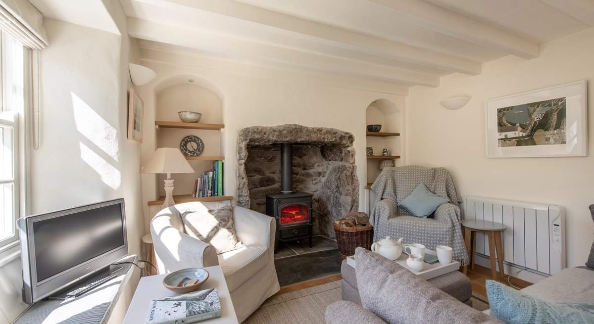 The sitting/dining-room with a roaring wood-burner.