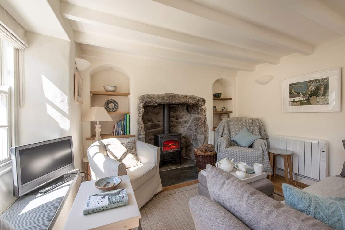 The sitting/dining-room with a roaring wood-burner.